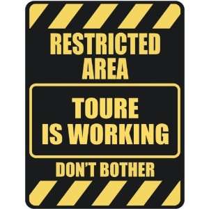   RESTRICTED AREA TOURE IS WORKING  PARKING SIGN