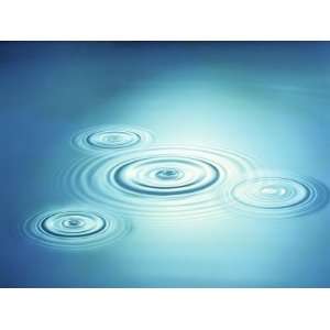 Multiple Rings in Blue Water with Bright Light Reflection Photographic 