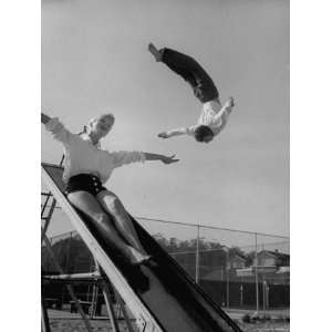 Acrobat and Actor Russ Tamblyn Doing a Flip at a Playground with Movie 