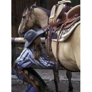 Female Wrangler Saddles Horse at Boulder River Ranch, Montana, USA Art 