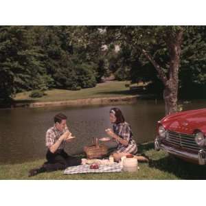  Young Couple Enjoying Picnic Near Lake in Spring or Summer 